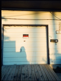 a white garage door with a shadow on it