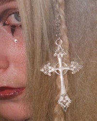 a woman with blond hair and a cross on her head