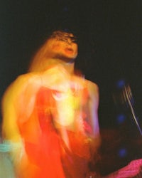 a blurry image of a woman in a red dress