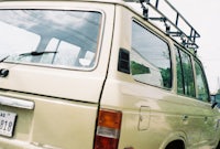 a tan suv parked on the street