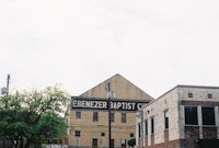 a brick building with a sign on it