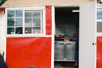 a red food truck with a door open