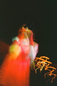 a blurry image of a woman in a red dress