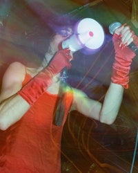 a man in a red shirt holding a megaphone