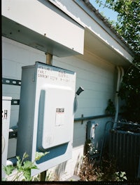 a metal box next to a house