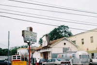 a street with cars parked in front of a gas station